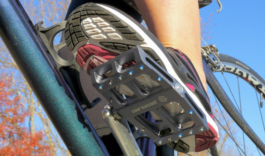 View, from below looking up, of a rider mashing down on a Grey Catalyst Pedal