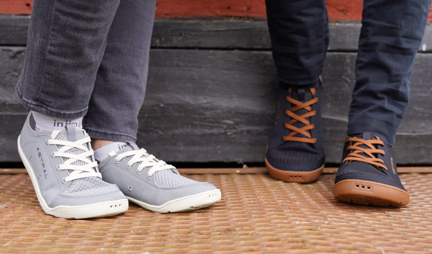 Male and female Astral Loyak shoe-wearers standing side by side on top of a metal grate