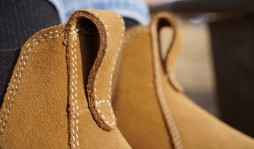 Close-up detail shot showing the suede upper of a pair of Lems Chelsea Boot Cedar boots