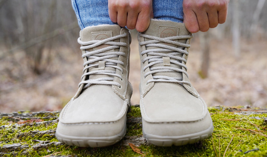 Front view showing a person straightening the tongue of their Lems Telluride Boot