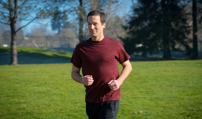 Dr. Ray McClanahan jogging in an urban park in Portland, OR