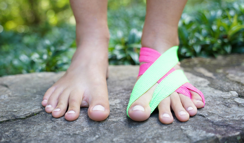 Pink and green BlackBoard ToeBands on the same foot