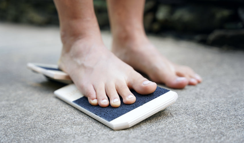 Right bare foot standing on a tilted BlackBoard Basic platform