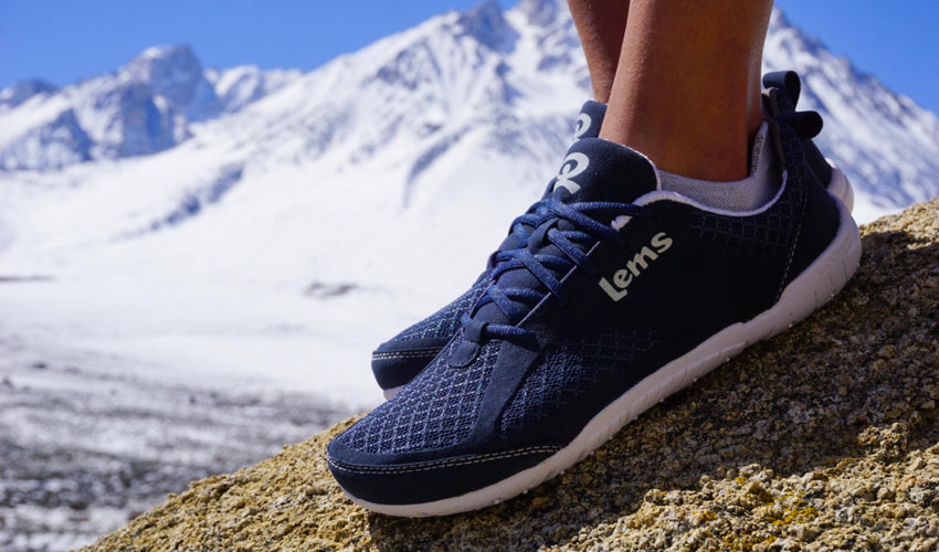 Female hiker wearing Lems Primal 2 Eclipse shoes