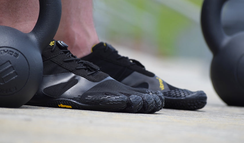 A side view of Vibram FiveFingers KSO shoes worn by an athlete using kettlebells