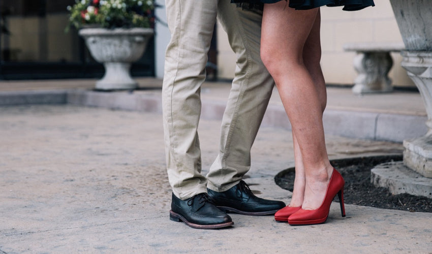 Couple being romantic while wearing injurious dress footwear