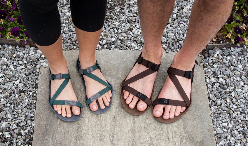 A top-down view of Xero Z-Trek athletic sandals worn by a man and a woman