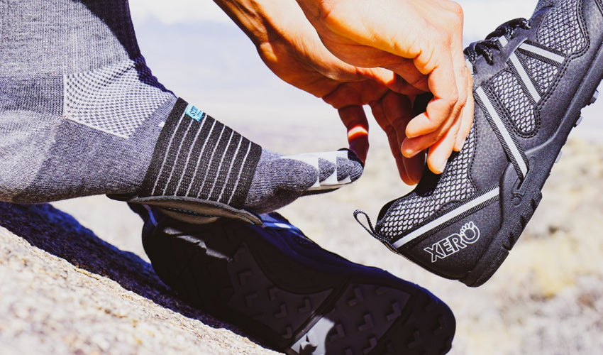 A combination of footgear, including Correct Toes, Injinji toe socks, Strutz foot pads, and Xero TerraFlex Black trail shoes