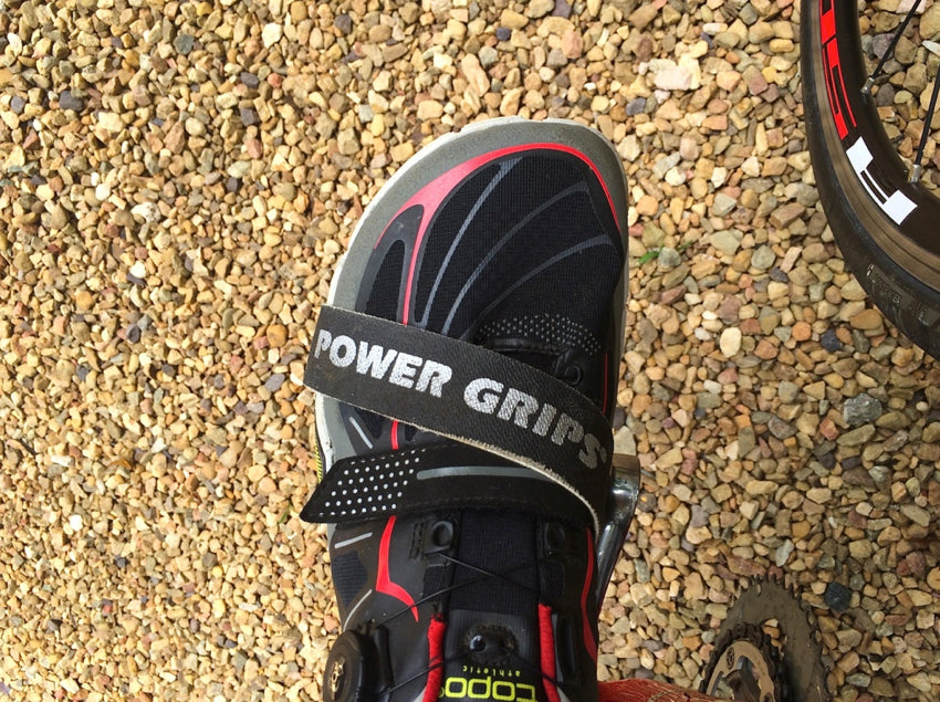 Topdown view of a Topo athletic shoe secured inside a pair of Power Grips pedal straps