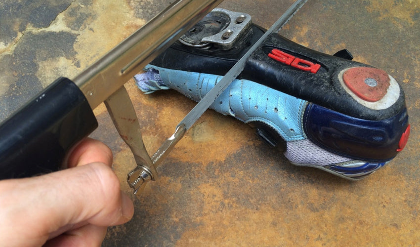Severing through the sole plate of a conventional road cycling shoe with a hacksaw