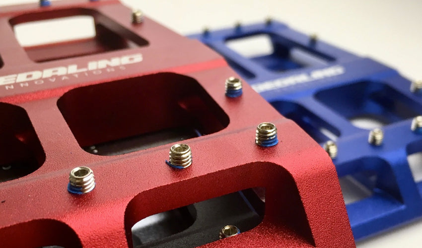 Close up view of several traction pins on the Red Catalyst Pedal
