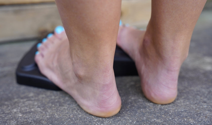 Person performing the post-exercise calf stretch phase of the ToePro protocol