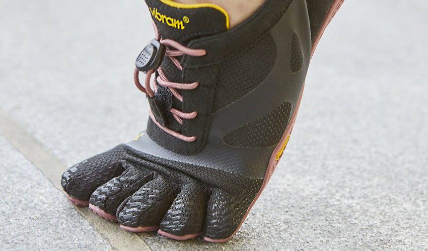 Close-up shot of a pair of Vibram FiveFingers KSO EVO shoes with dorsiflexed toes/toe sleeves