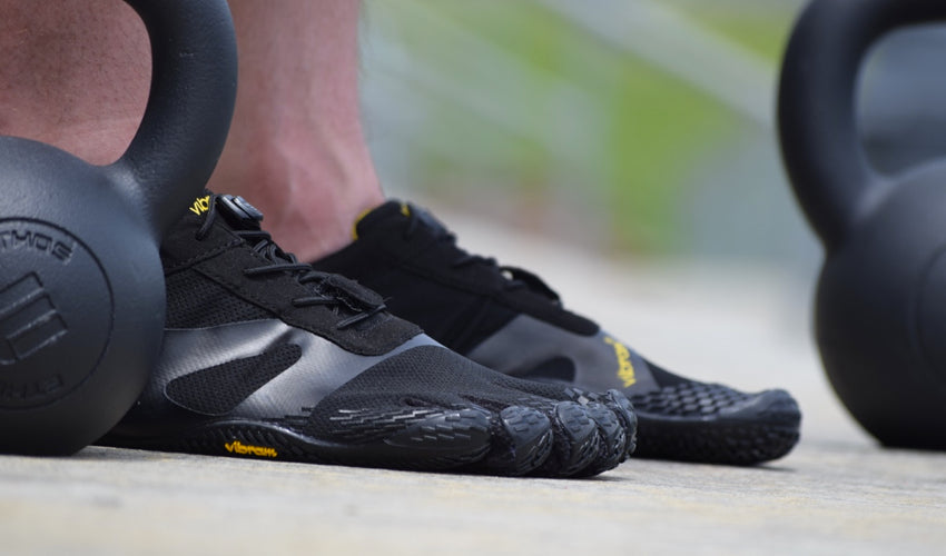 Close-up view of a pair of Vibram FiveFingers KSO EVO shoes and kettlebell