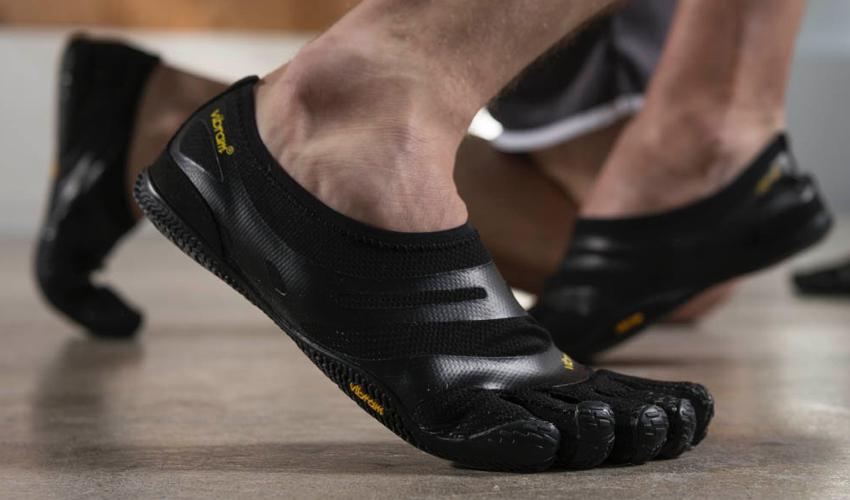 The feet of a wrestler wearing a pair of Vibram FiveFingers toe shoes