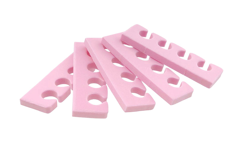 A close-up view of a stack of pink pedicure toe spreaders used for toenail painting