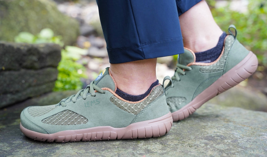 Side view of the feet of a Lems Primal 3 Olive shoe wearer