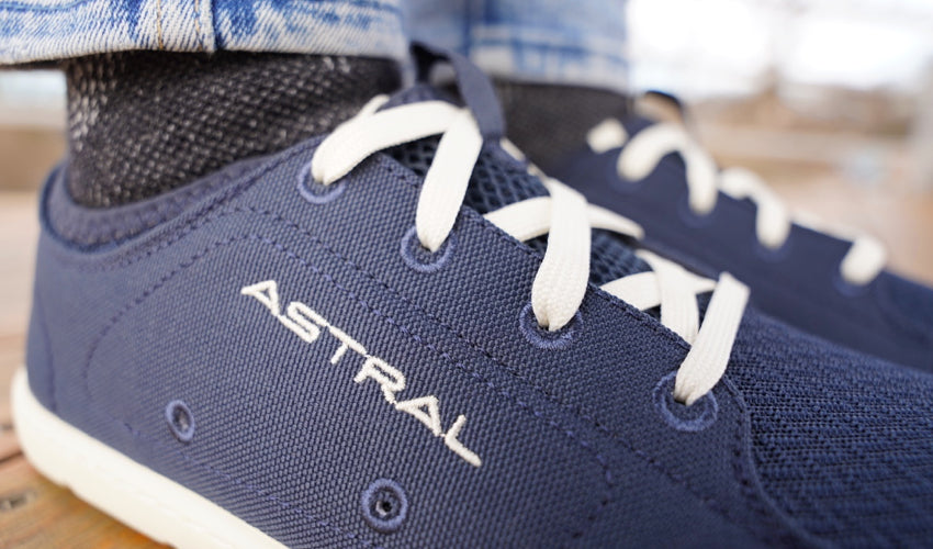 A close-up view of the upper of an Astral Loyak shoe in Navy/White