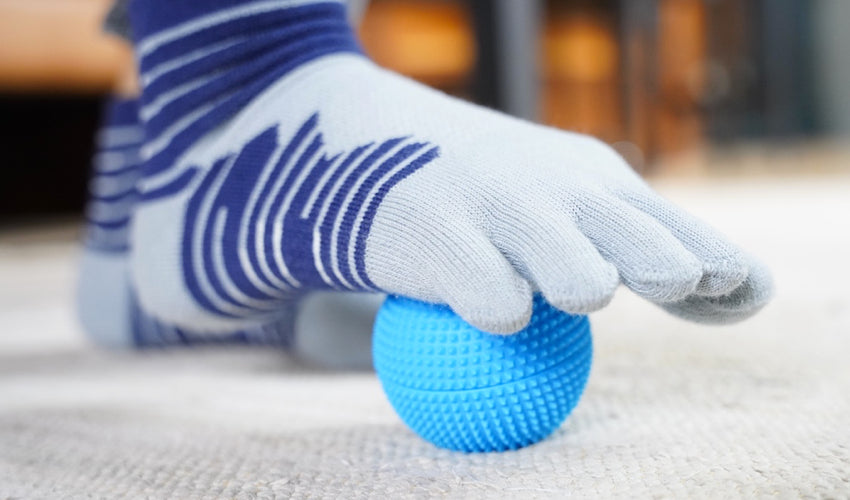 A foot resting on top of a Naboso Neuro Ball