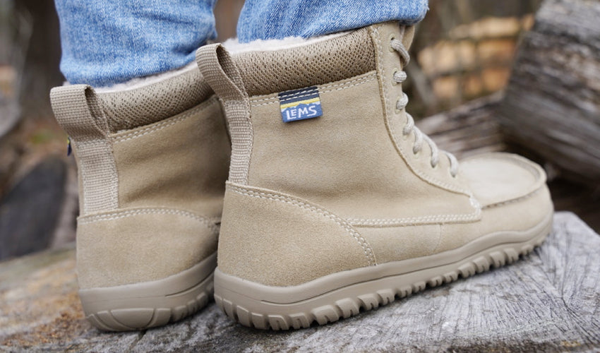 Rear-diagonal view of a pair of Lems Telluride Boots in Limestone color