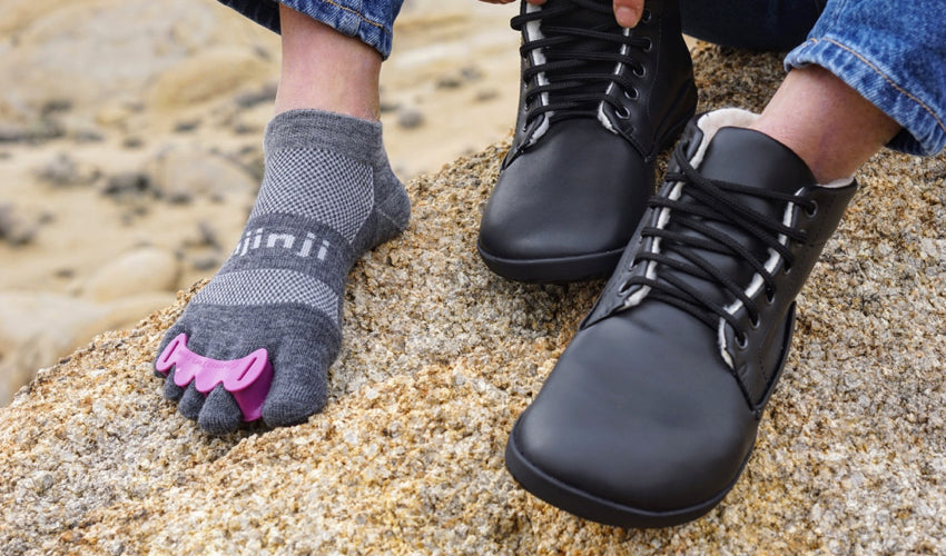 A hiker sporting a pair of Correct Toes Plum toe spacers as well as other natural footgear
