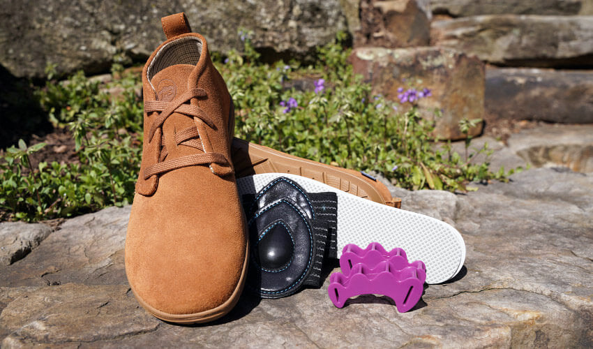 An array of complementary natural footgear, including Lems Chukka boots, Correct Toes Plum toe spacers, Strutz Pro Black foot pads, and Naboso Neuro insoles