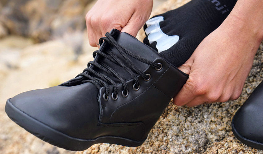 A hiker wearing Correct Toes Original toe spacers and Injinji toe socks donning an Ahinsa trekking boot