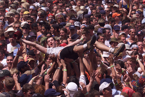 image of man crowd surfing at woodstock 99'