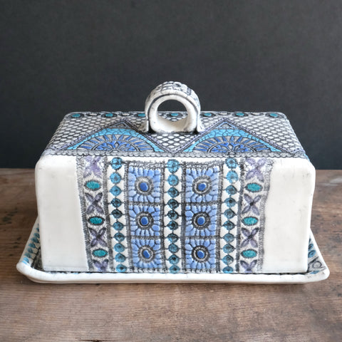 Rectangular butter dish in shades of blue with a mountain design and a small one finger handle on top