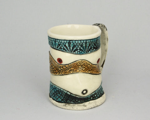 Handmade mug in white, blue, and brown, with the shape of breasts and a belly.