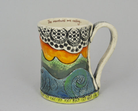 Handmade mug with stylized waves and sunset with lace pattern.
