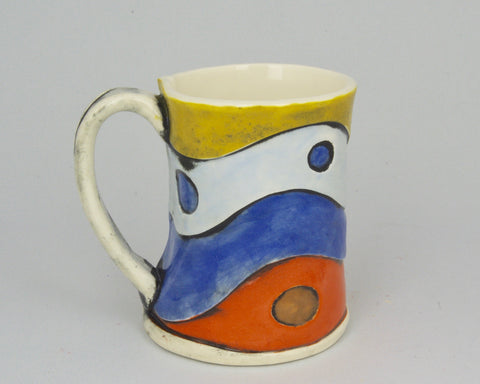 Handmade mug with wavy design in red, blue, grey and yellow. 