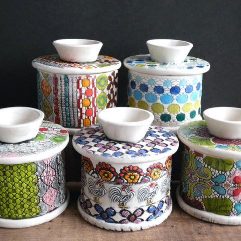 A collection of highly decorative and colourful french butter dishes.