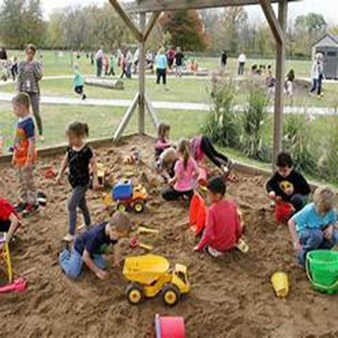 Showes children playing at a playground or park.