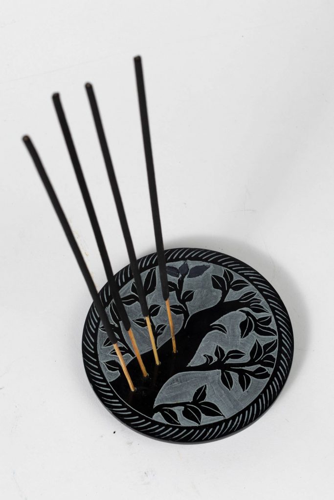 Ethical stocking stuffer, the Tree of Life Incense Holder is shown with 4 sticks of incense burning in it. 