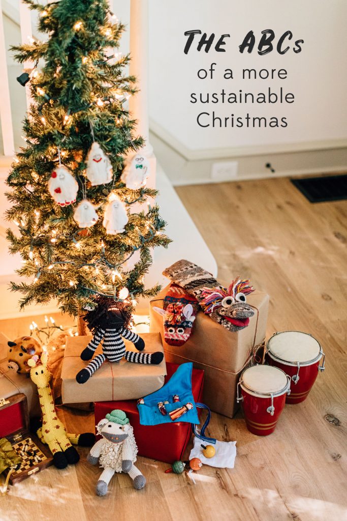 The ABCs of a more sustainable Christmas. Image shows a small lit-up tree with fair trade gifts, wrapped sustainably, below. 