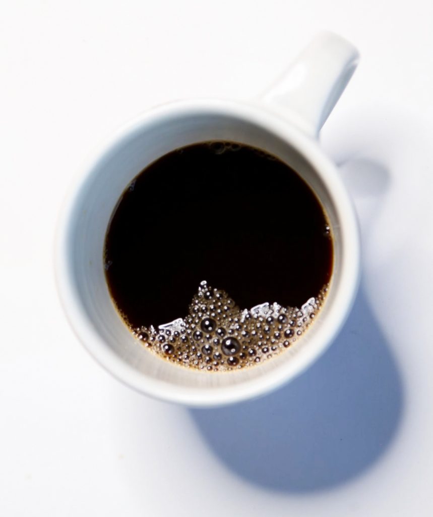 Shot of a white mug filled with fair trade coffee, taken from above. 