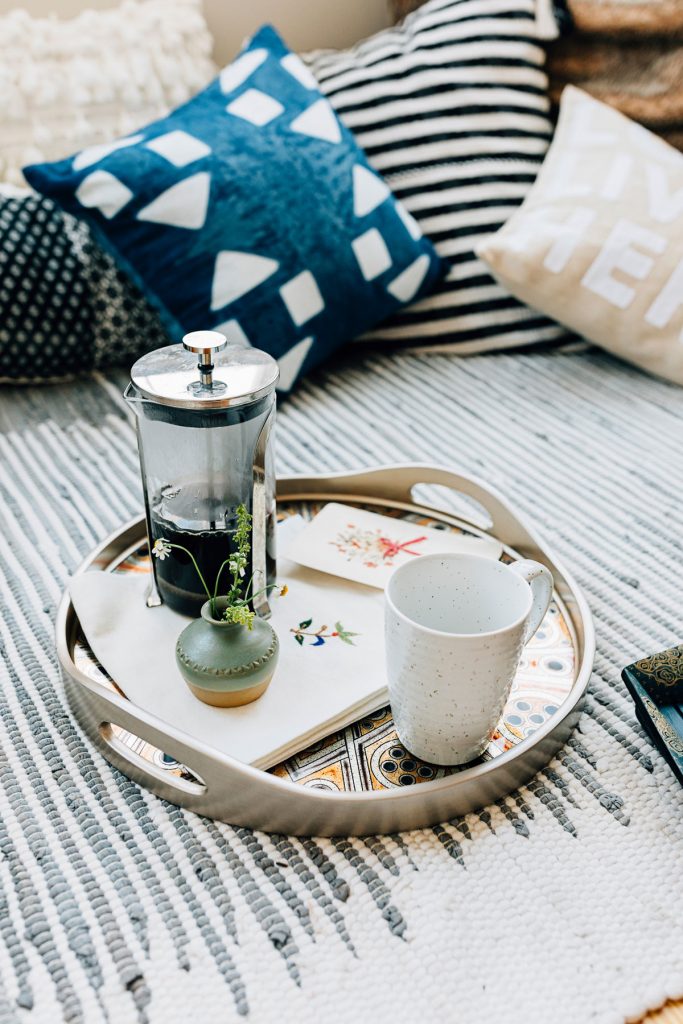 French Press and handcrafted ceramic mug on a serving tray. 