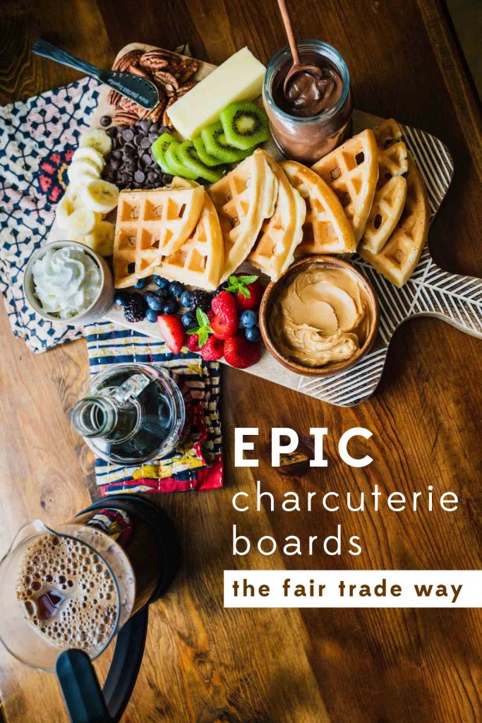 Image of the Minimalist Serving Board with hand etching covered with waffles, fruit and condiments. Text reads, Epic Charcuterie Boards the Fair Trade Way.