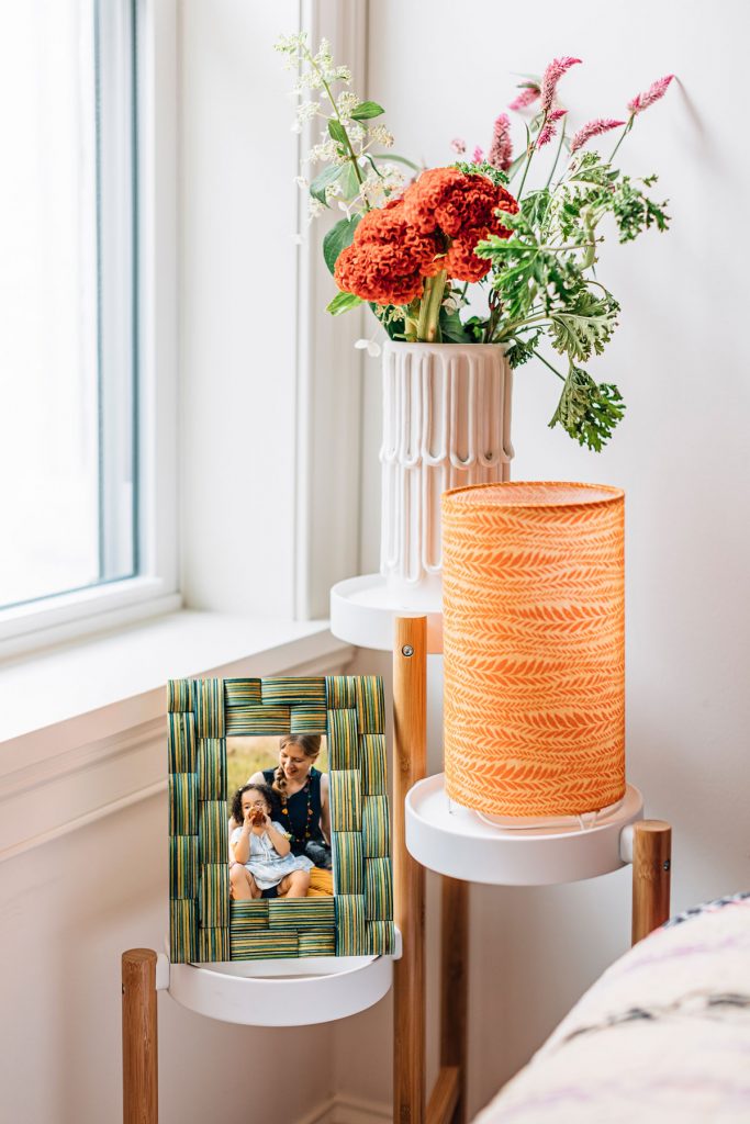 Image features the Forest Ferns Mood Lamp and fair trade picture frame in a bedroom space. How to rest and work from home. 