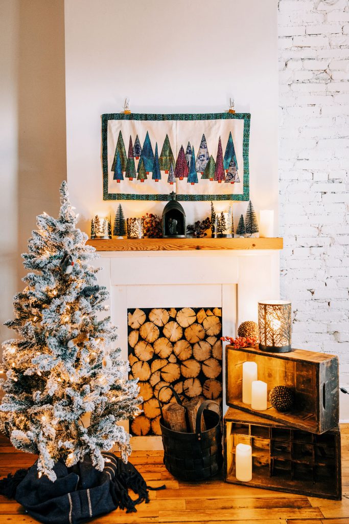 Styling a rustic mantle with a handmade kantha stitched wall hanging taking center stage. 