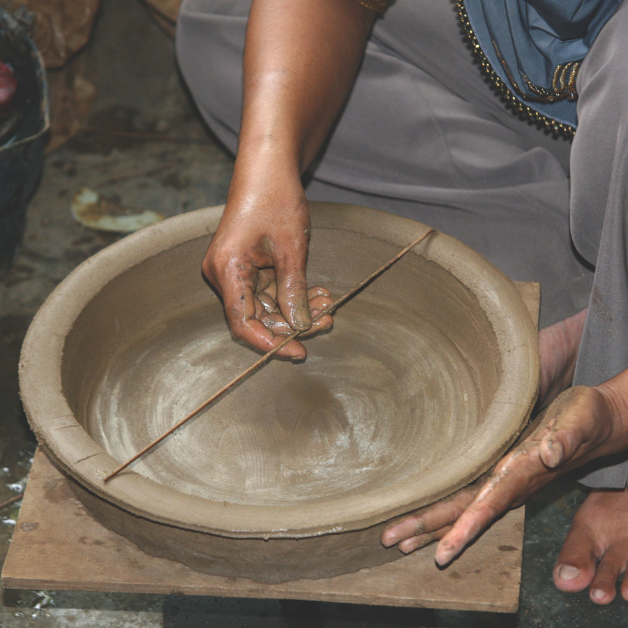 Craftsmanship. Inaq Aziz, clay craftsman, creates hand-thrown, hand-shaped pottery.