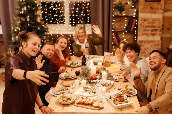 Family enjoying a Christmas meal and taking a selfie.
