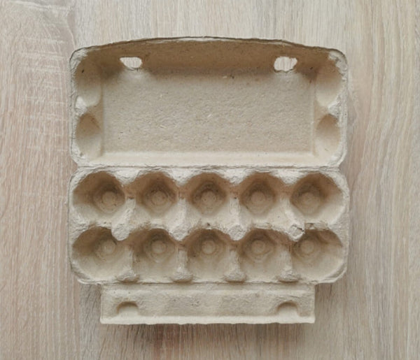 Open egg carton on a wooden surface, top view.