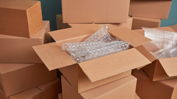 Pile of cardboard boxes with bubble wrap for packing or moving.