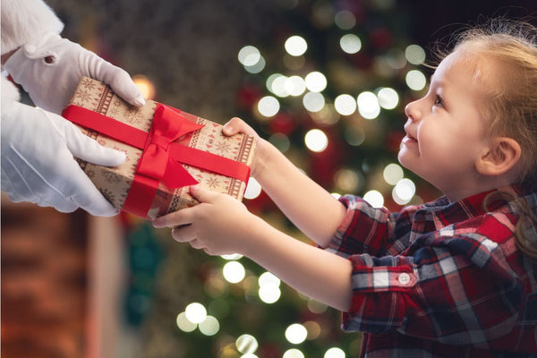 Child receiving gift from Santa.