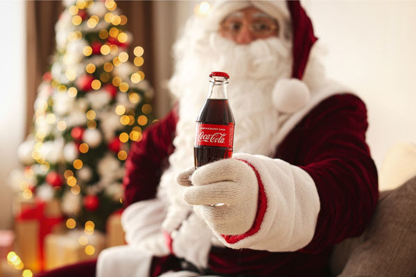 Santa holding a cola bottle.