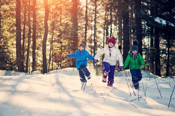 Kids playing in the snow on a sunny winter day.