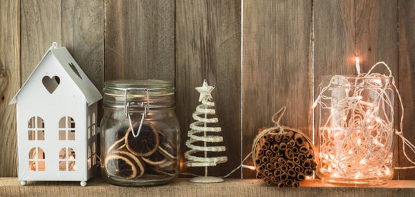 Rustic holiday decorations with lights and natural materials on wood.