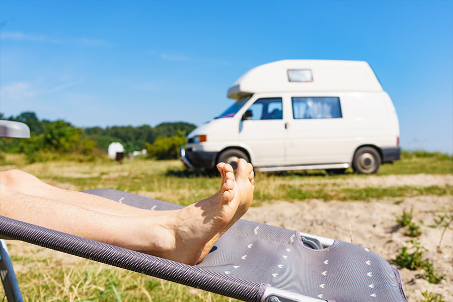 Relaxing beside a small VW campervan